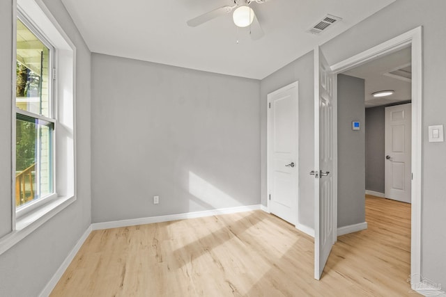 unfurnished room with ceiling fan and light wood-type flooring