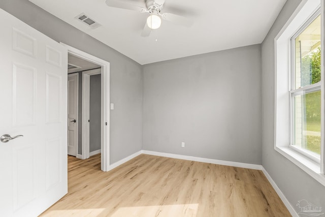 unfurnished bedroom with multiple windows, light hardwood / wood-style flooring, and ceiling fan