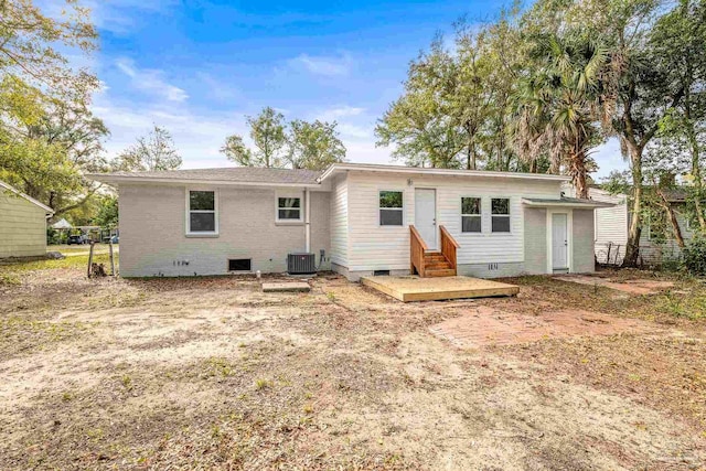 back of property featuring central AC