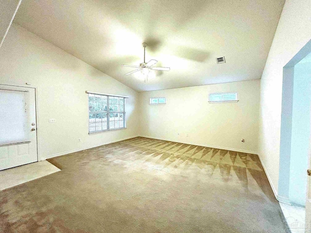 unfurnished living room featuring ceiling fan, carpet, and vaulted ceiling