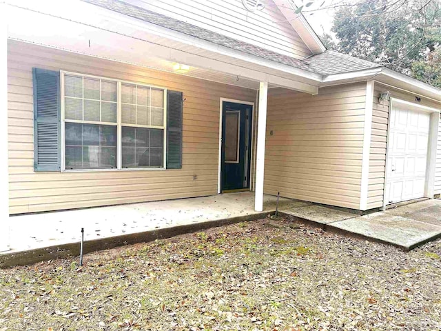 view of exterior entry featuring a garage