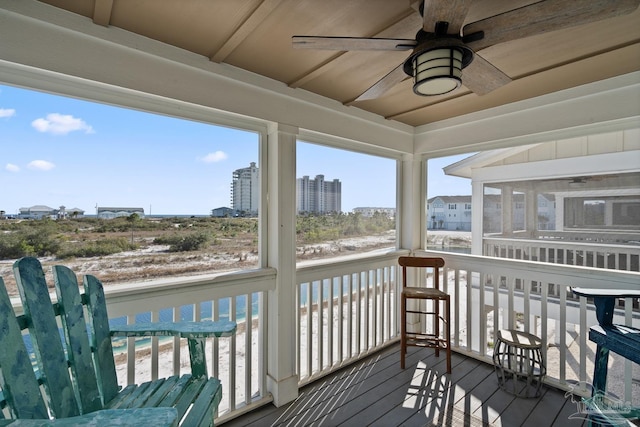 deck featuring a city view and ceiling fan