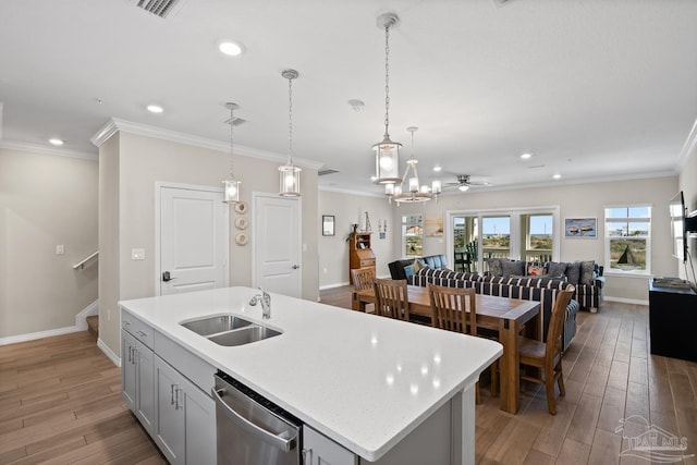 kitchen with light wood finished floors, crown molding, ceiling fan, dishwasher, and a sink