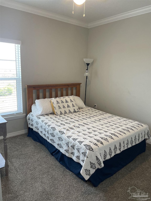 carpeted bedroom featuring crown molding and baseboards