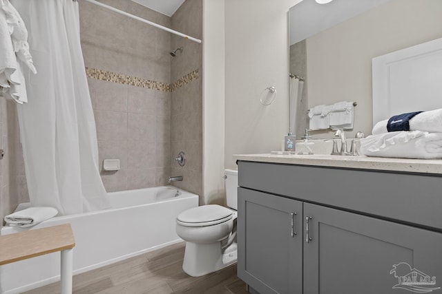 full bathroom featuring shower / bath combination with curtain, toilet, vanity, and wood finished floors