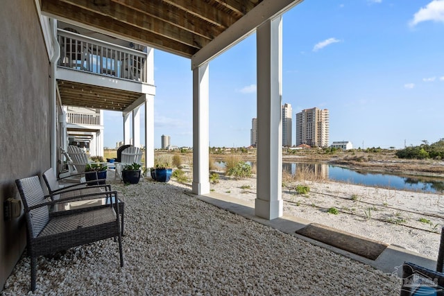 view of patio with a view of city and a water view