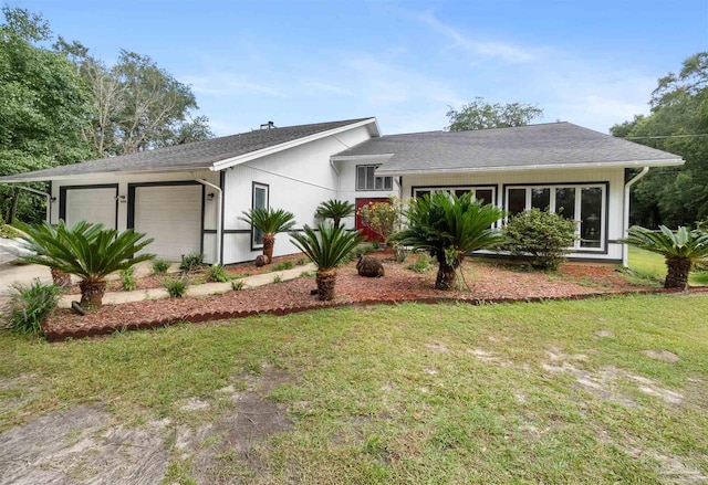 view of front of home with a garage and a front yard