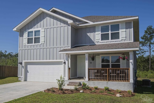 view of front of house featuring a garage, central air condition unit, and a porch