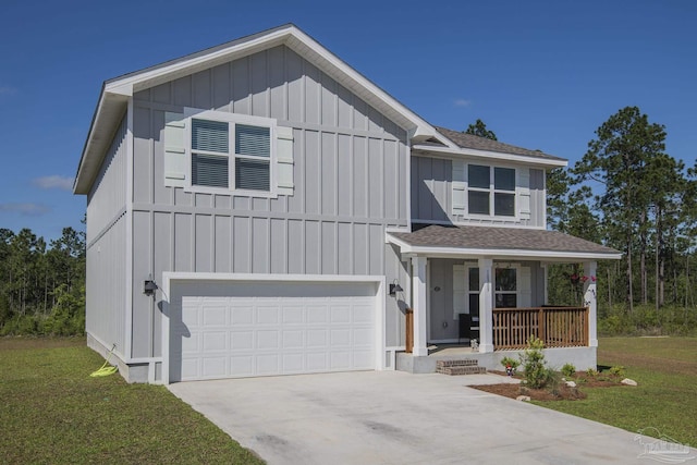 view of front of house featuring a porch, a garage, and a front yard