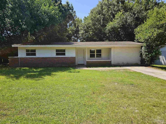 ranch-style home with concrete driveway, brick siding, and a front lawn