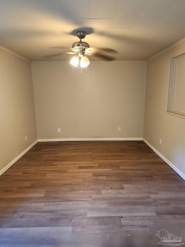 spare room featuring a ceiling fan, crown molding, baseboards, and wood finished floors