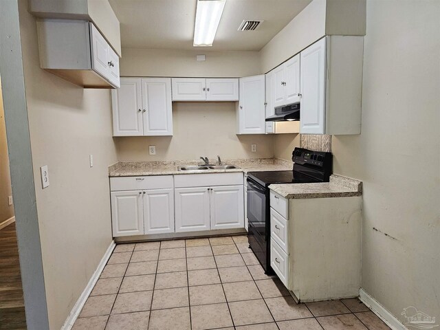 kitchen featuring white cabinetry, sink, light tile patterned flooring, and black range with electric cooktop