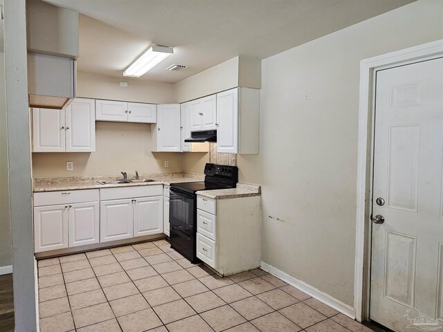 kitchen featuring white cabinetry, light tile patterned flooring, black range with electric stovetop, and sink