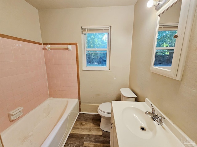 full bathroom with toilet, vanity, wood finished floors, and a wealth of natural light