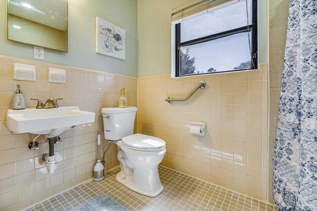 bathroom with tile walls, tasteful backsplash, and toilet