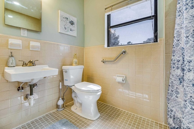 bathroom with sink, tile walls, tile patterned flooring, toilet, and a shower with shower curtain