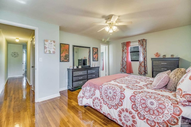 bedroom with ceiling fan and hardwood / wood-style floors