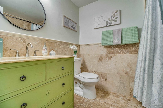 bathroom featuring toilet, tile walls, a shower with shower curtain, and vanity