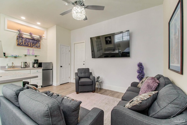 living room featuring light hardwood / wood-style flooring and ceiling fan