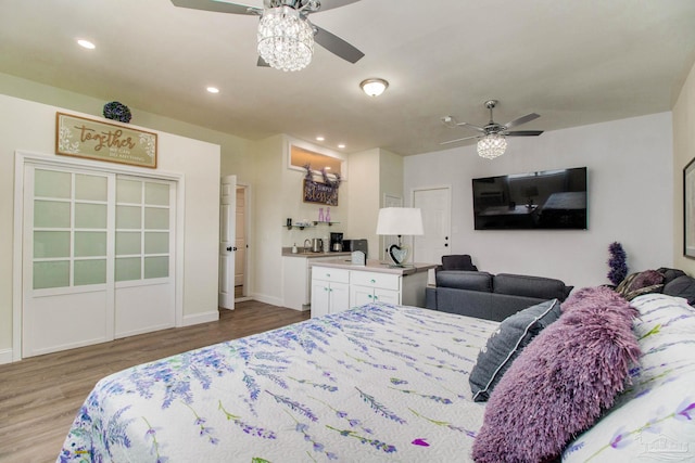 bedroom with hardwood / wood-style floors and ceiling fan