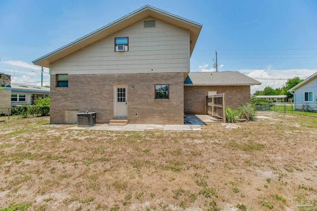 back of house with central AC, a patio, and a yard