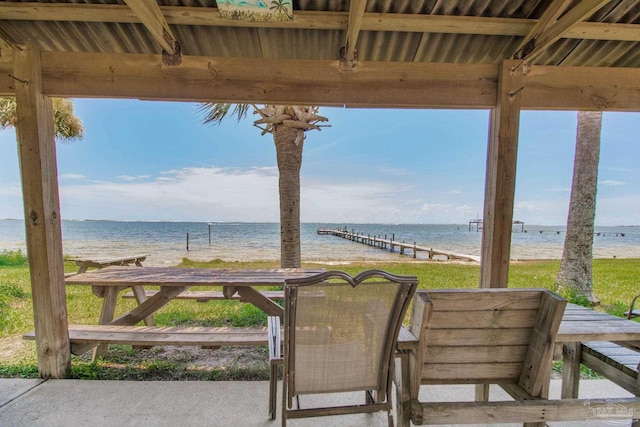 view of patio / terrace featuring a water view and a beach view