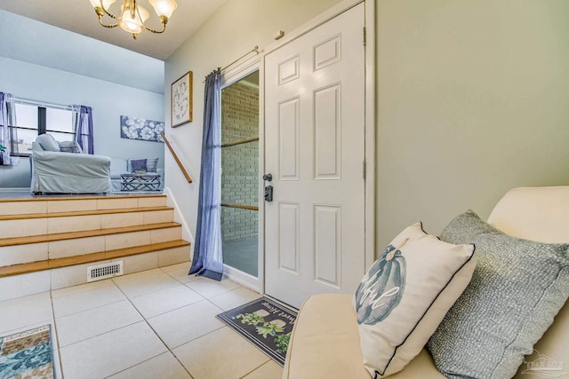 doorway featuring an inviting chandelier and light tile patterned floors