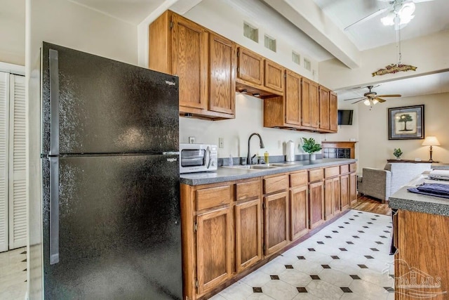 518 W Strong St Unit A & B, Pensacola, FL 32501 - kitchen with a sink, freestanding refrigerator, a ceiling fan, brown cabinets, and beamed ceiling