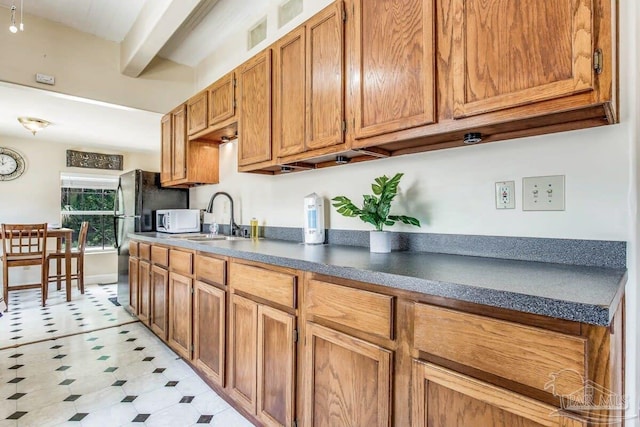 518 W Strong St Unit A & B, Pensacola, FL 32501 - kitchen with a sink, dark countertops, brown cabinets, beam ceiling, and white microwave