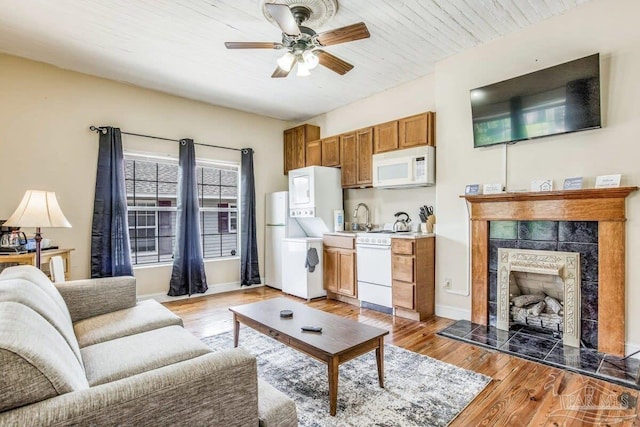 518 W Strong St Unit A & B, Pensacola, FL 32501 - living area with light wood finished floors, a tile fireplace, baseboards, and a ceiling fan