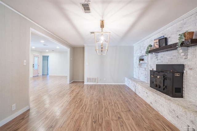 unfurnished living room featuring hardwood / wood-style flooring and ornamental molding