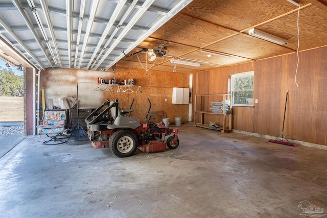 garage featuring a garage door opener and wood walls