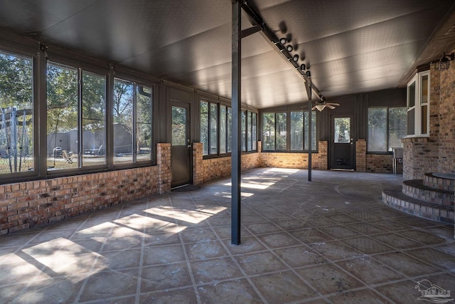 unfurnished sunroom featuring vaulted ceiling