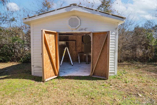 view of outdoor structure featuring a lawn