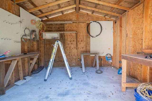 misc room featuring vaulted ceiling and a workshop area