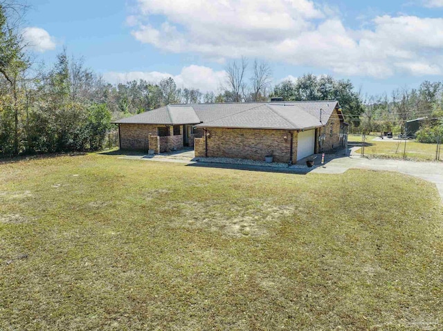 ranch-style house featuring a garage and a front yard