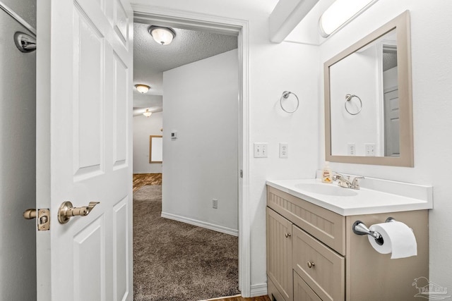 bathroom with vanity and a textured ceiling