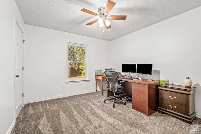 carpeted home office featuring ceiling fan and a textured ceiling