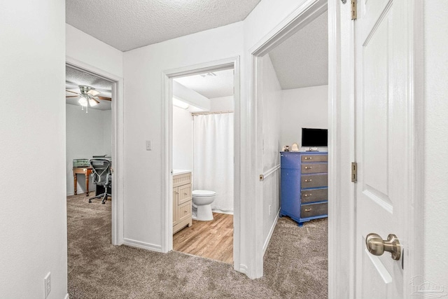 interior space with ceiling fan and light colored carpet