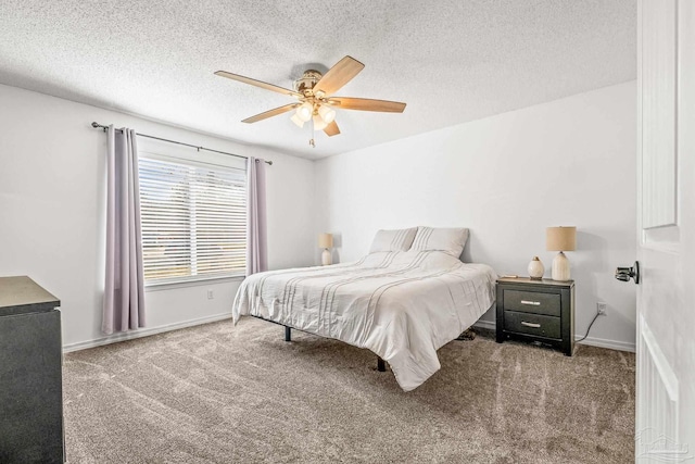 carpeted bedroom featuring a textured ceiling and ceiling fan