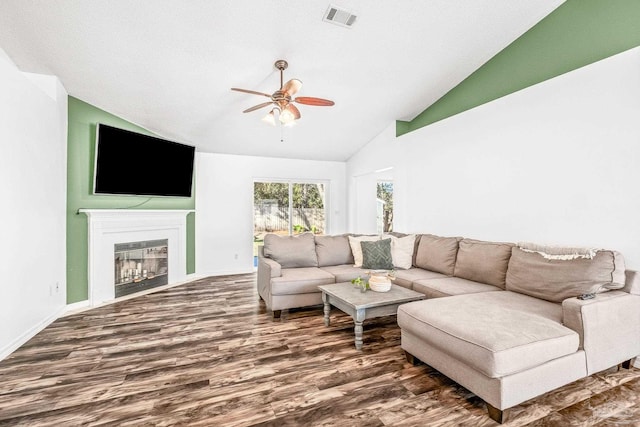 living room featuring dark hardwood / wood-style flooring, high vaulted ceiling, and ceiling fan