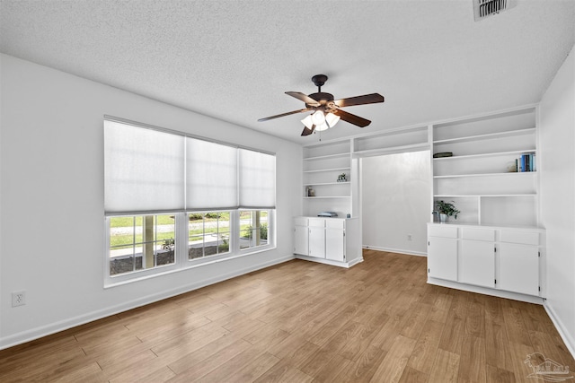 1213 Tecumseh Pl, Pensacola, FL 32514 - empty room with a ceiling fan, light wood-style flooring, and a textured ceiling