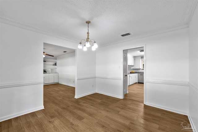 1213 Tecumseh Pl, Pensacola, FL 32514 - unfurnished dining area with a textured ceiling, crown molding, wood finished floors, a chandelier, and a ceiling fan