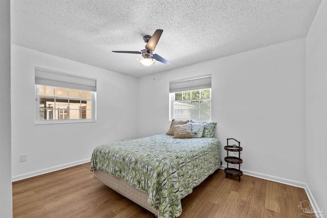 1213 Tecumseh Pl, Pensacola, FL 32514 - bedroom with wood finished floors, a textured ceiling, and a ceiling fan