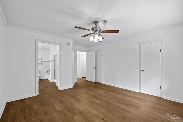 1213 Tecumseh Pl, Pensacola, FL 32514 - unfurnished bedroom featuring crown molding, wood finished floors, ensuite bathroom, ceiling fan, and two closets