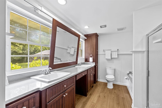 1213 Tecumseh Pl, Pensacola, FL 32514 - bathroom with wood finished floors, double vanity, and wainscoting