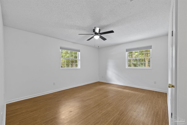 1213 Tecumseh Pl, Pensacola, FL 32514 - unfurnished room featuring wood finished floors, a ceiling fan, plenty of natural light, and a textured ceiling