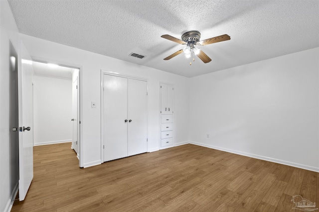 1213 Tecumseh Pl, Pensacola, FL 32514 - unfurnished bedroom featuring a textured ceiling, wood finished floors, a closet, and a ceiling fan