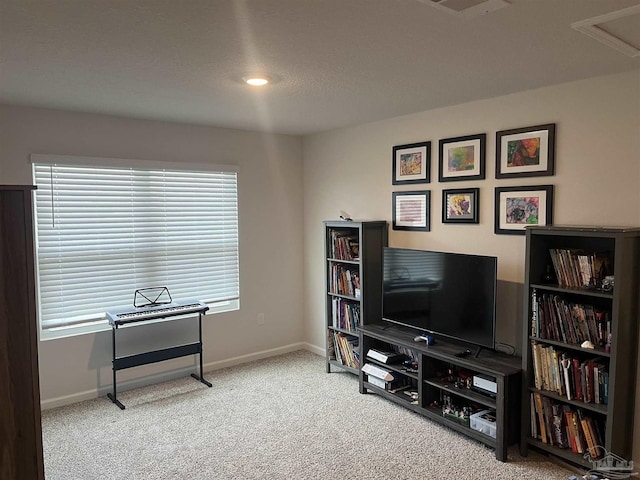 sitting room featuring baseboards, visible vents, and carpet