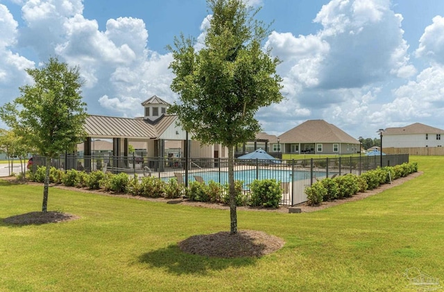 pool with a yard and fence